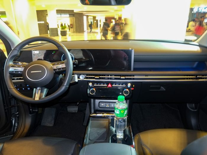 Large widescreen display fitted across a modern dashboard